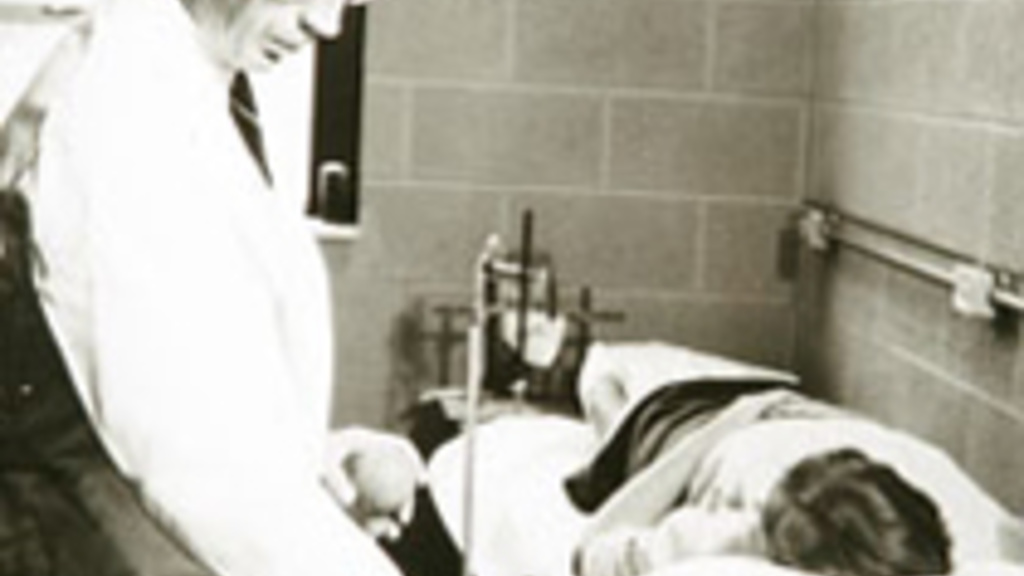 Clinican performing an exam in an old patient room
