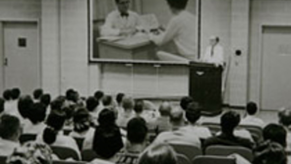 Students in an old lecture hall B/W